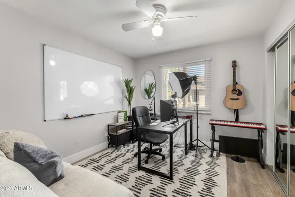 a living room with furniture and a wooden floor