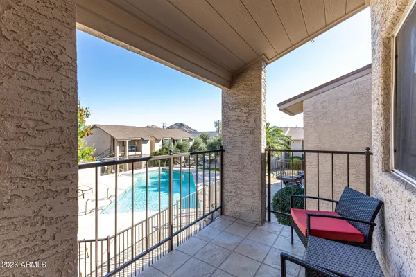 a balcony filled with furniture