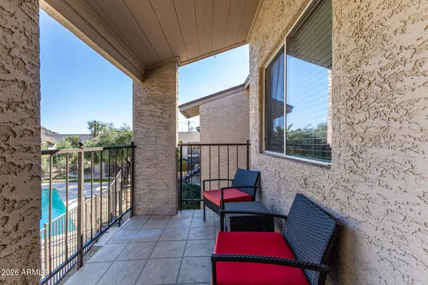 a porch with a table and chairs