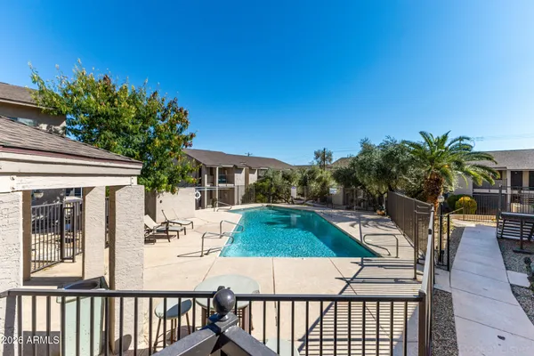 front view of house with a yard and potted plants