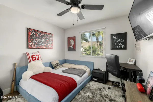 a bedroom with a bed and a window