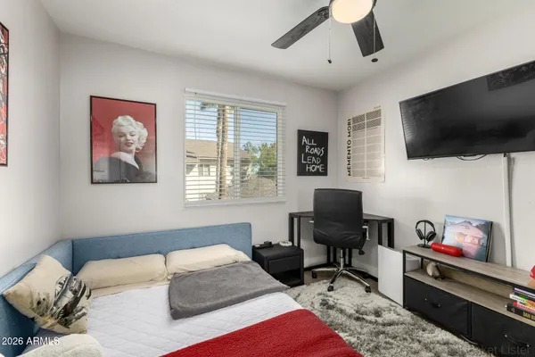 a bedroom with a workspace