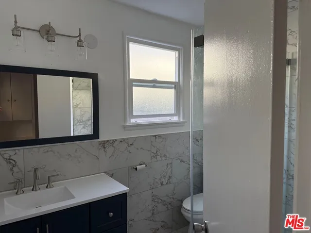 a bathroom with a sink toilet and mirror