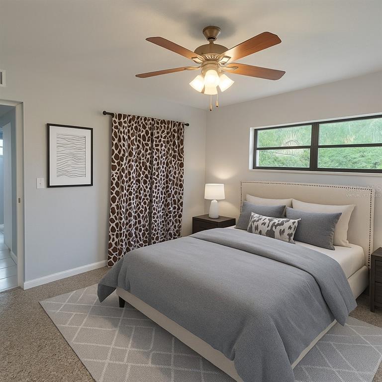 461 South Brevard Avenue, Unit 18 Cocoa Beach, FL 32931 - Photo 16 of 24 a bedroom with a bed and a chandelier