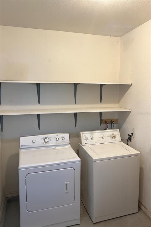 461 South Brevard Avenue, Unit 18 Cocoa Beach, FL 32931 - Photo 17 of 24 a utility room with dryer and washer