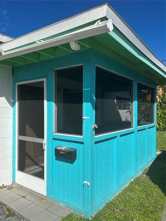 461 South Brevard Avenue, Unit 18 Cocoa Beach, FL 32931 - Photo 2 of 24 a front view of a house with a green gate