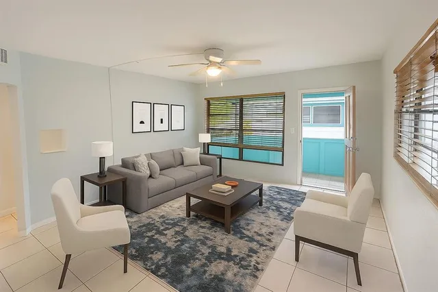 a living room with furniture and a large window