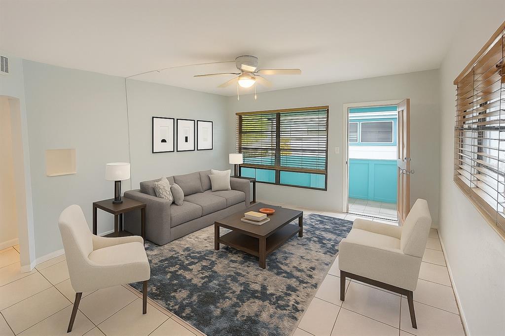 461 South Brevard Avenue, Unit 18 Cocoa Beach, FL 32931 - Photo 10 of 24 a living room with furniture and a large window