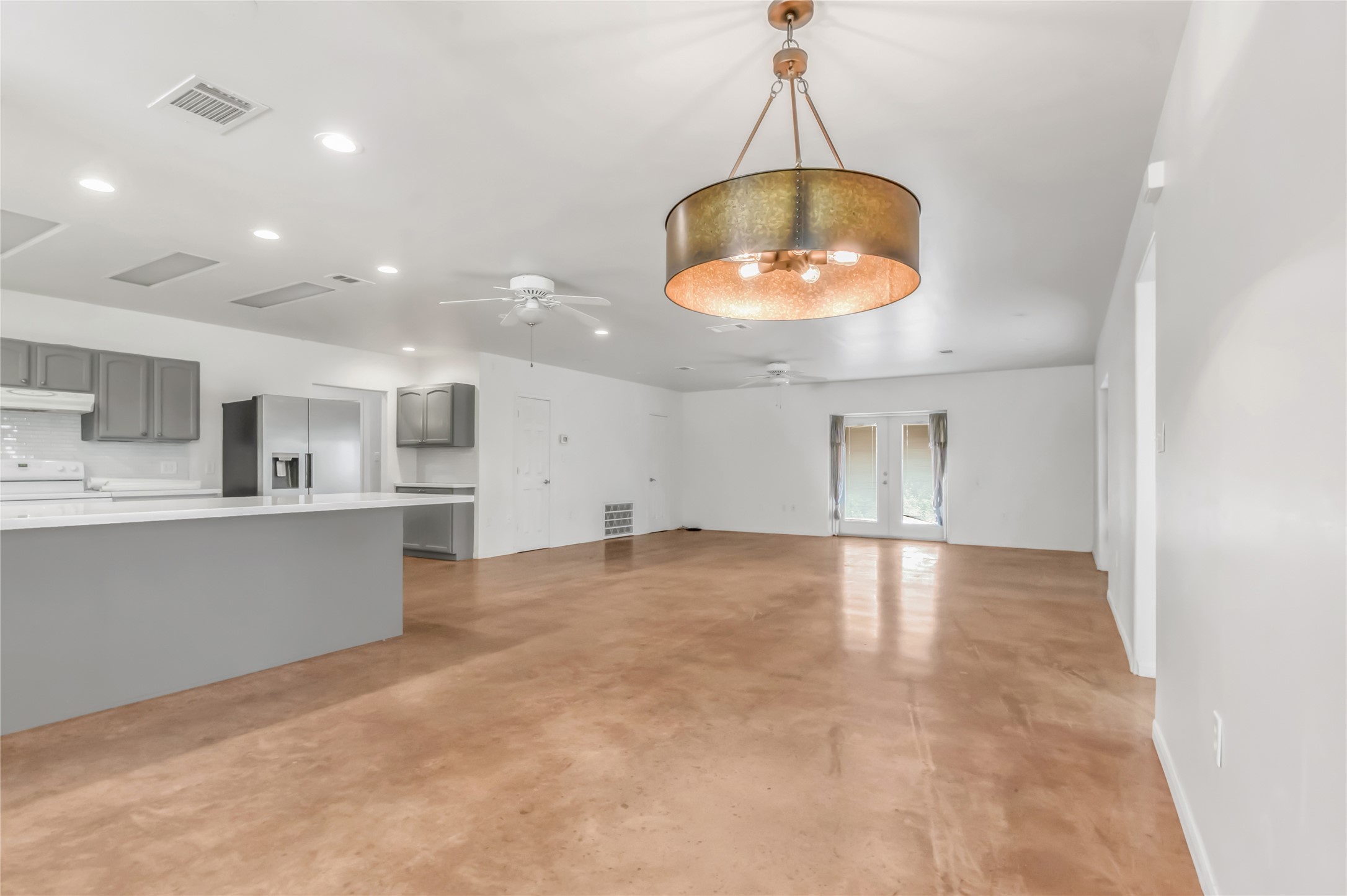 1004 22 Hills Road Gause, TX 77857 - Photo 31 of 37 An open-concept living space with polished concrete flooring and a modern kitchen.