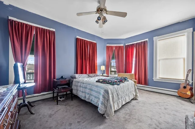 a bedroom with a bed and a tv in it