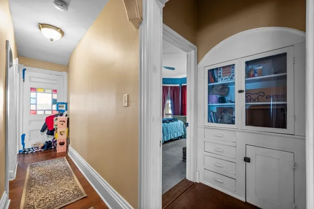 a view of hallway with wooden floor