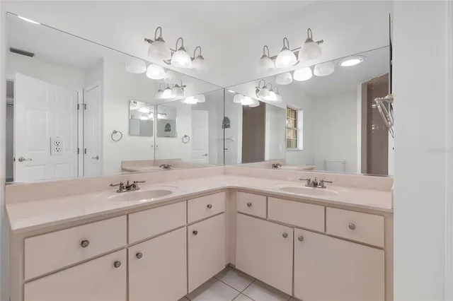 a bathroom with a sink vanity granite and a mirror