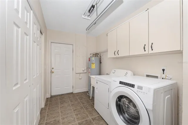 a view of washer and dryer with kitchen in the background
