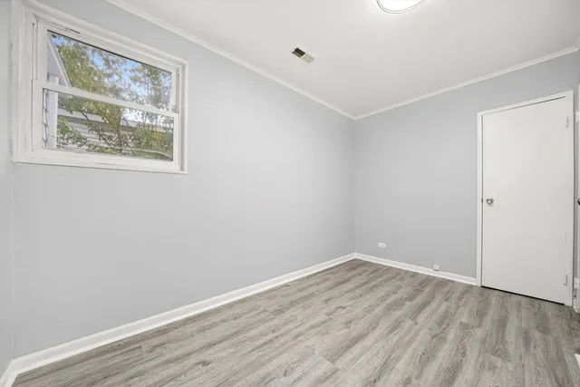 a room with wooden floor and window