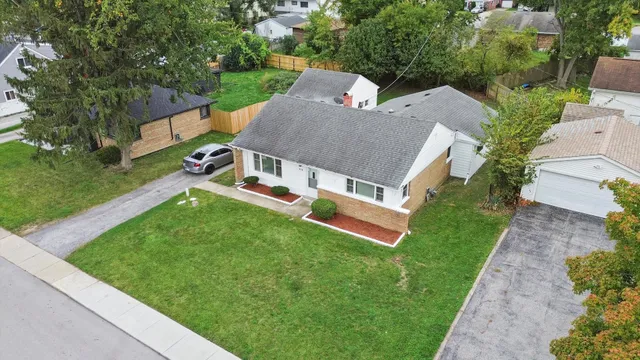 an aerial view of a house with a garden and trees