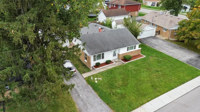 an aerial view of a house with a big yard