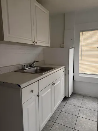 a kitchen with a sink and cabinets