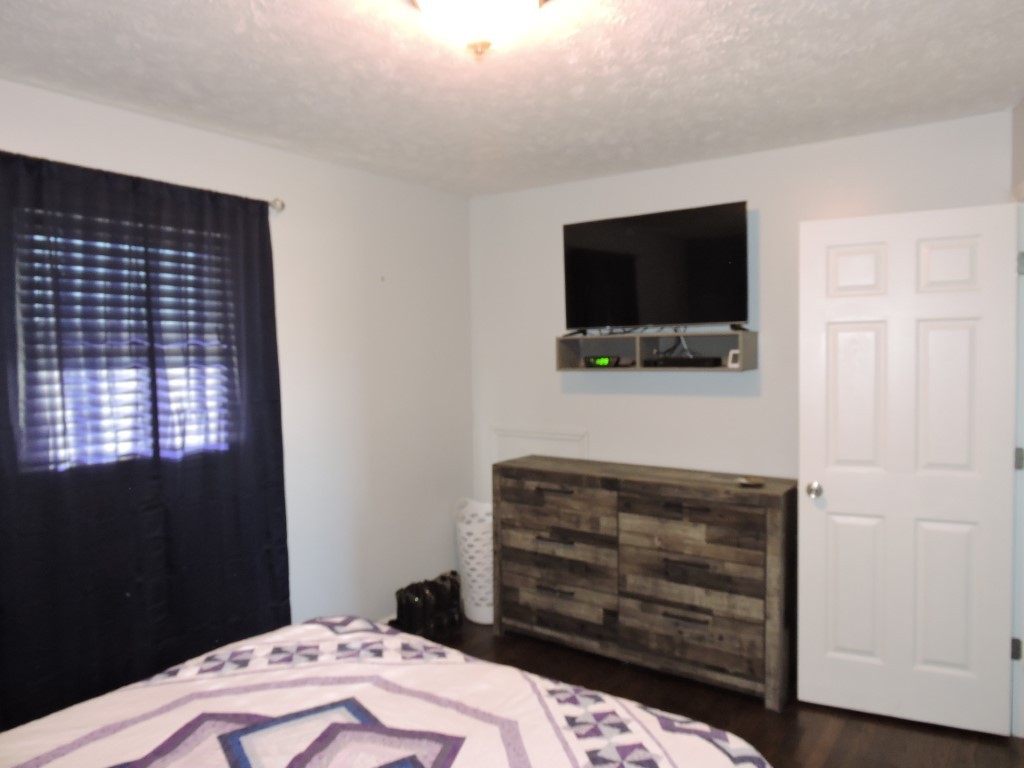 166 Sixteenth Model Road Manchester, TN 37355 - Photo 9 of 17 a bedroom with a bed and a flat screen tv