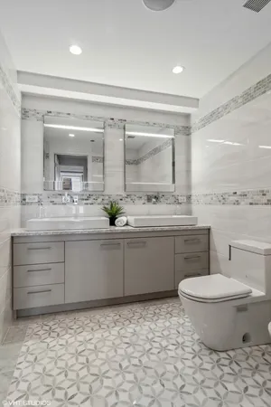 a bathroom with a sink toilet and mirror