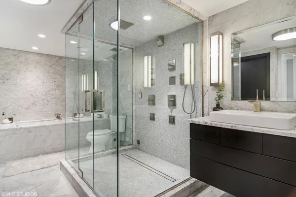 a bathroom with a granite countertop sink mirror and shower
