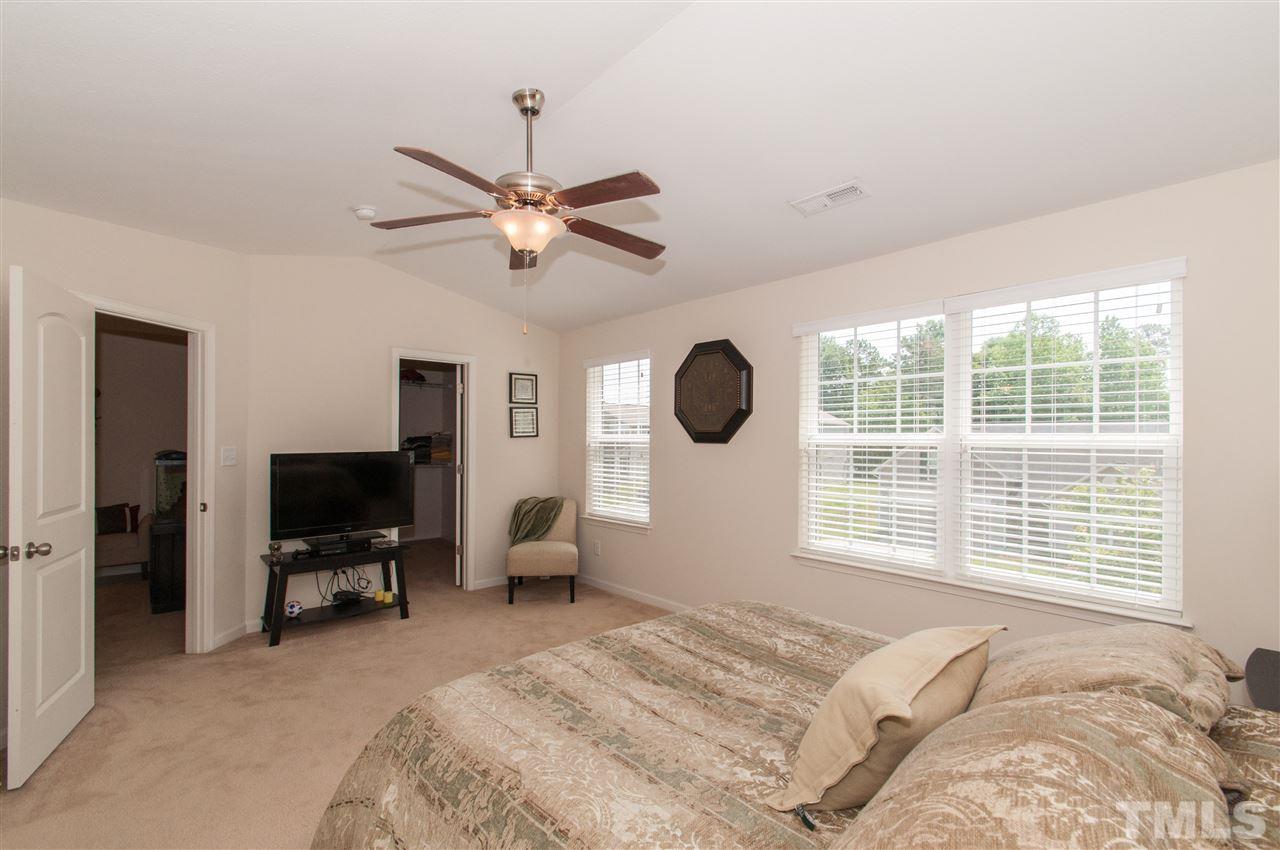6412 Flanking Lane Raleigh, NC 27610 - Photo 11 of 22 a bedroom with a bed flat screen tv and a window