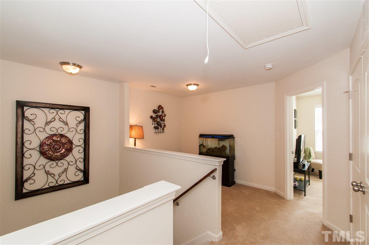 6412 Flanking Lane Raleigh, NC 27610 - Photo 15 of 22 a view of a hallway with paintings on the wall