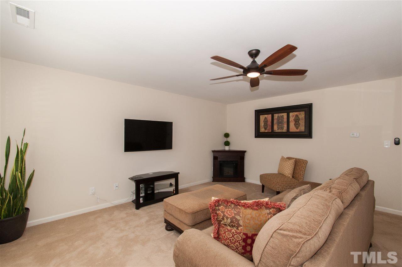 6412 Flanking Lane Raleigh, NC 27610 - Photo 3 of 22 a living room with furniture and a flat screen tv