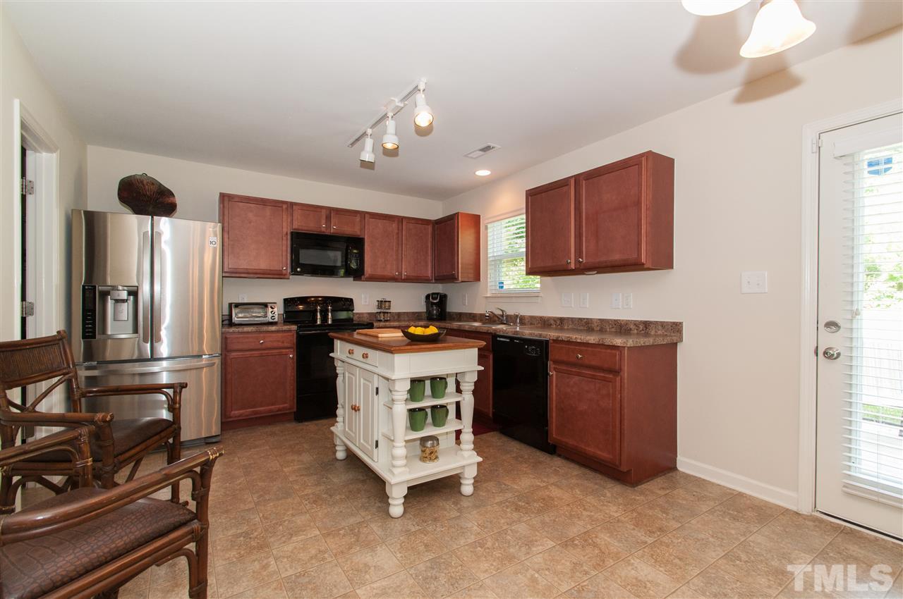 6412 Flanking Lane Raleigh, NC 27610 - Photo 6 of 22 a kitchen with a refrigerator stove and microwave