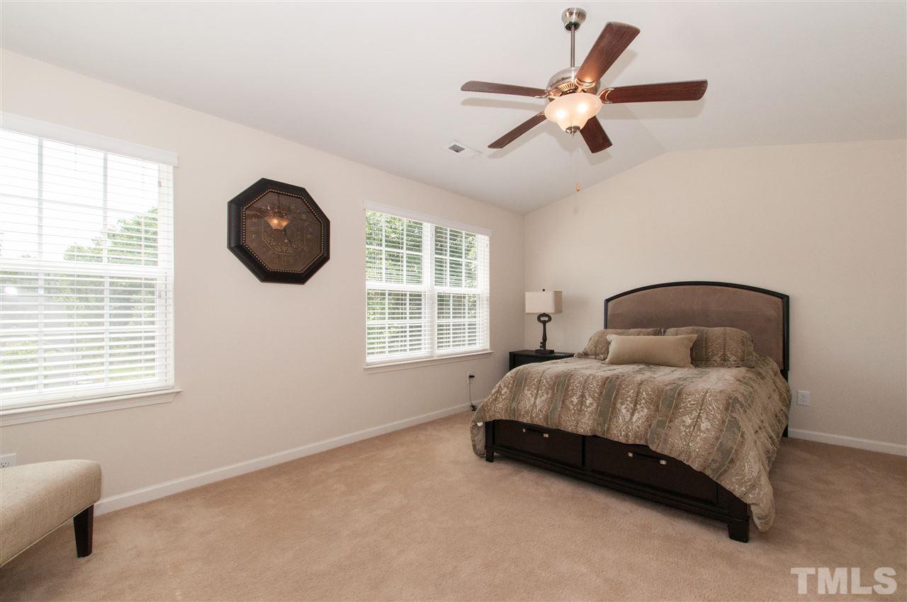 6412 Flanking Lane Raleigh, NC 27610 - Photo 10 of 22 a spacious bedroom with a bed and a large window