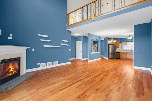 a view of an empty room with a fireplace and a window