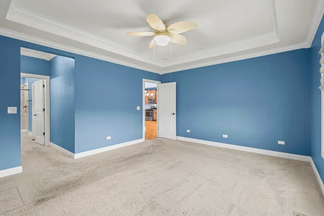 a view of an empty room with a ceiling fan