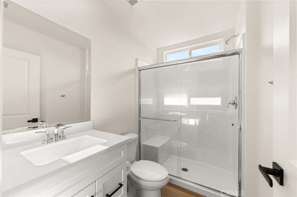 19434 Arenal Way Riverside, CA 92508 - Photo 14 of 25 a bathroom with a sink mirror toilet and shower