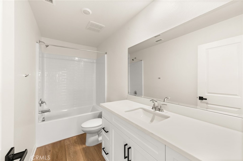 19434 Arenal Way Riverside, CA 92508 - Photo 17 of 25 a bathroom with a sink toilet tub and shower