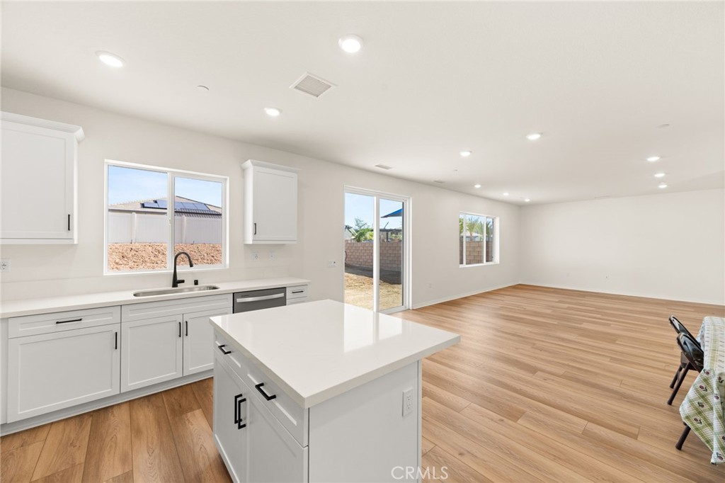 19434 Arenal Way Riverside, CA 92508 - Photo 7 of 25 a kitchen with a sink cabinets and wooden floor