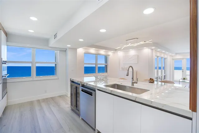 a kitchen with stainless steel appliances granite countertop a sink and a stove top oven
