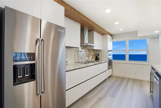 a kitchen with stainless steel appliances a refrigerator sink and microwave