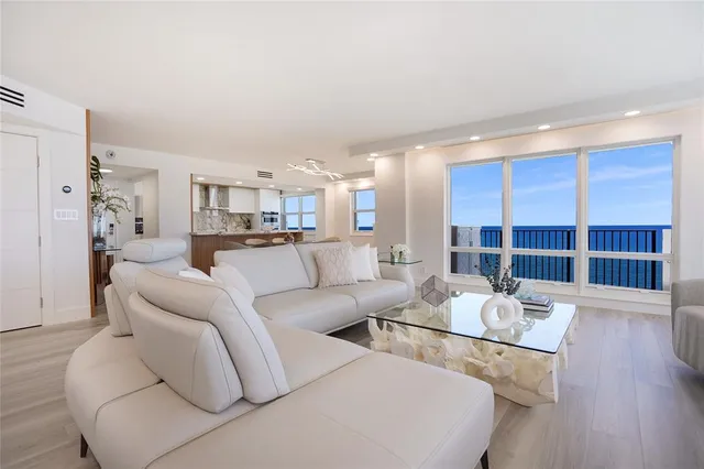 a living room with furniture or kitchen view and a wooden floor