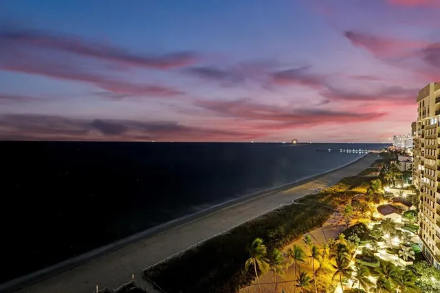 a living room with furniture and a mirror