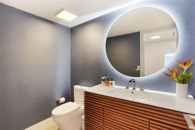 a bedroom with a bed and a table lamp