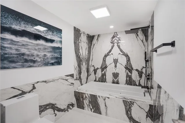 a view of walk in closet with clothes