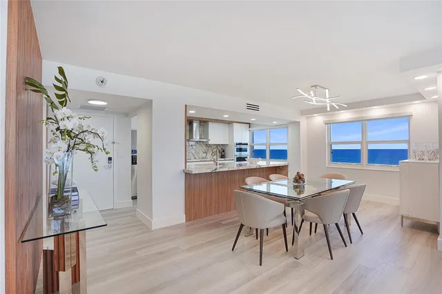 a dining room with furniture and wooden floor