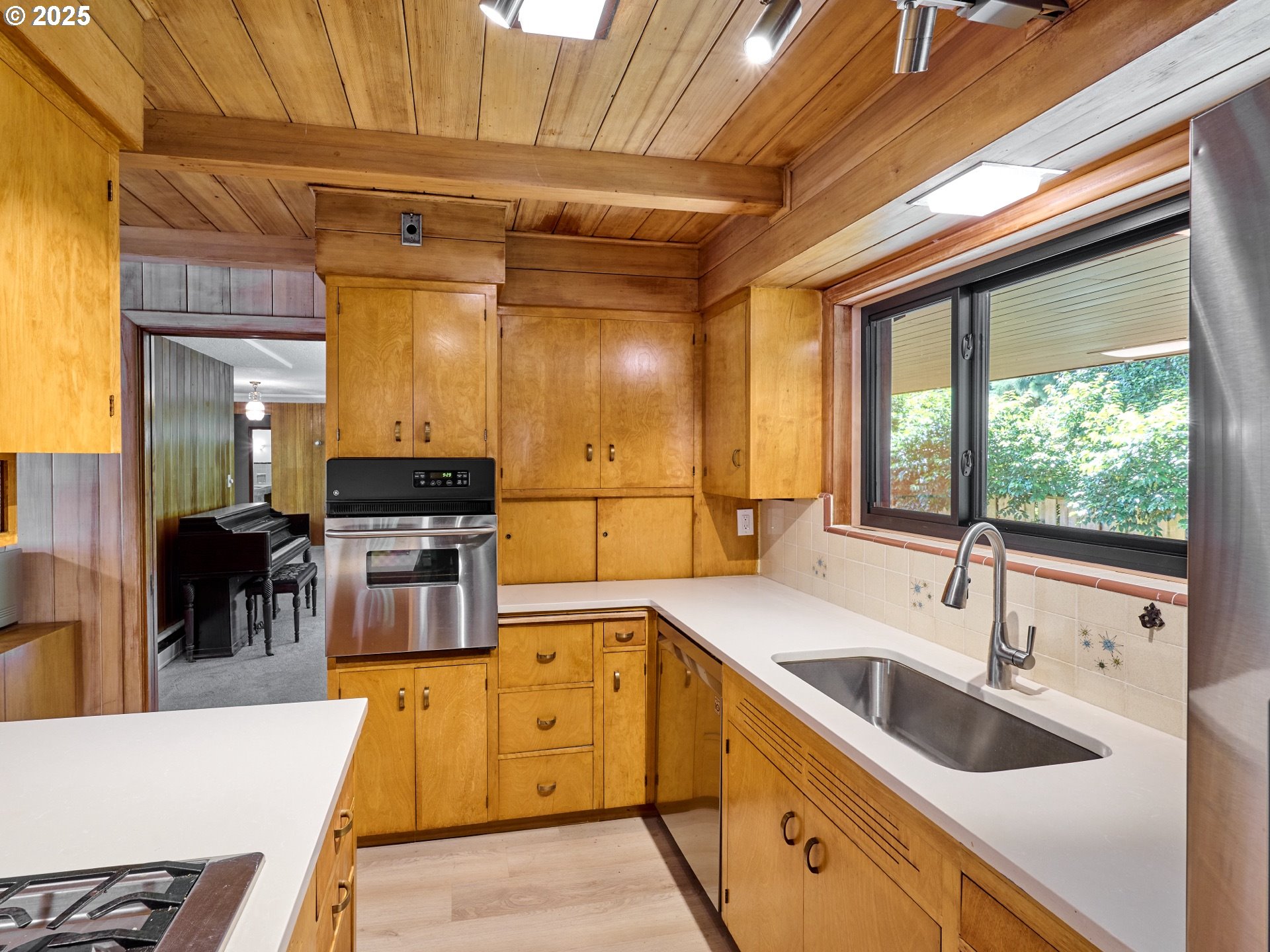 790 Southeast Webber Street, Unit 401 Portland, OR 97202 - Photo 12 of 43 a kitchen with stainless steel appliances granite countertop sink stove and cabinets