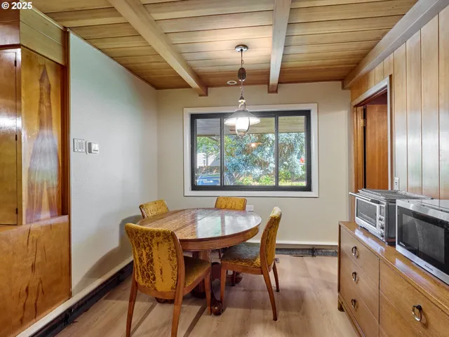 a dining room with furniture and window