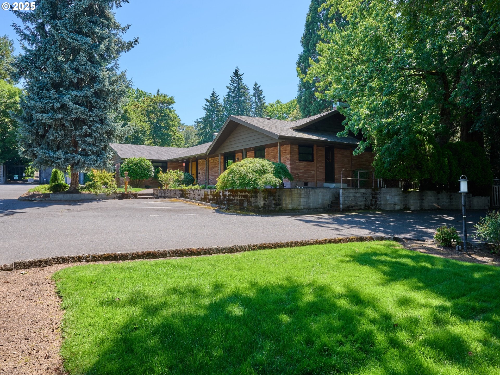 790 Southeast Webber Street, Unit 401 Portland, OR 97202 - Photo 2 of 43 a front view of a house with a yard and trees