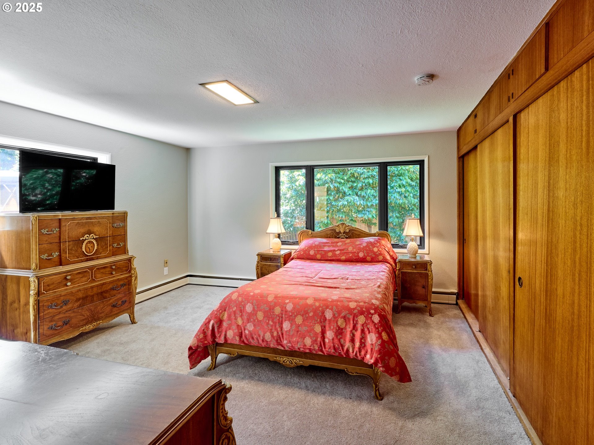 790 Southeast Webber Street, Unit 401 Portland, OR 97202 - Photo 22 of 43 a bedroom with a bed and flat screen tv