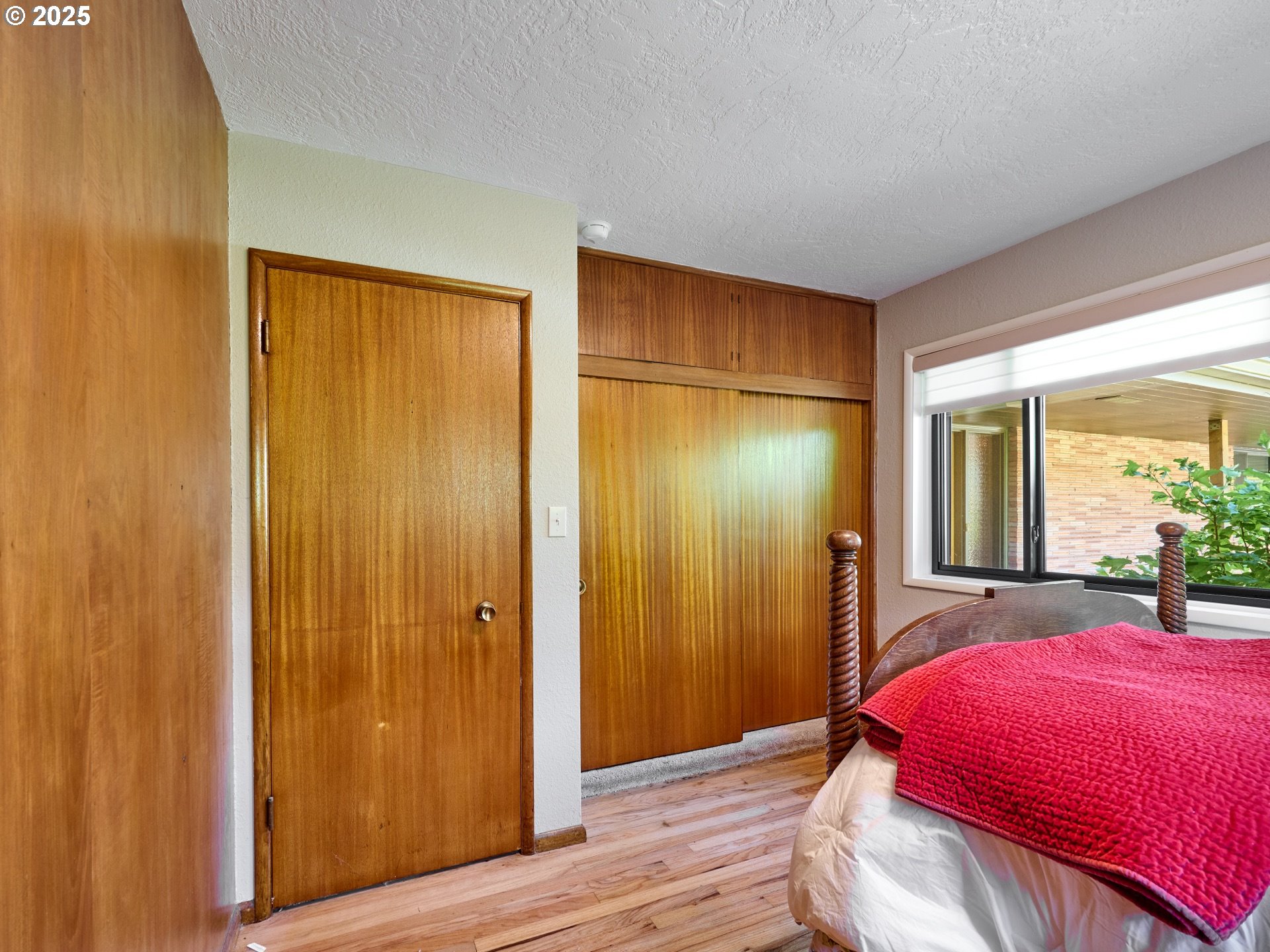 790 Southeast Webber Street, Unit 401 Portland, OR 97202 - Photo 27 of 43 a bed room with a bed and a mirror