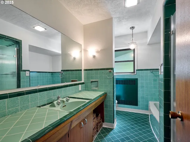 a bathroom with a double vanity sink and a large mirror