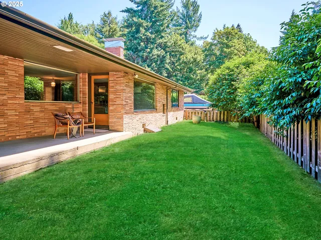 a backyard of a house with table and chairs