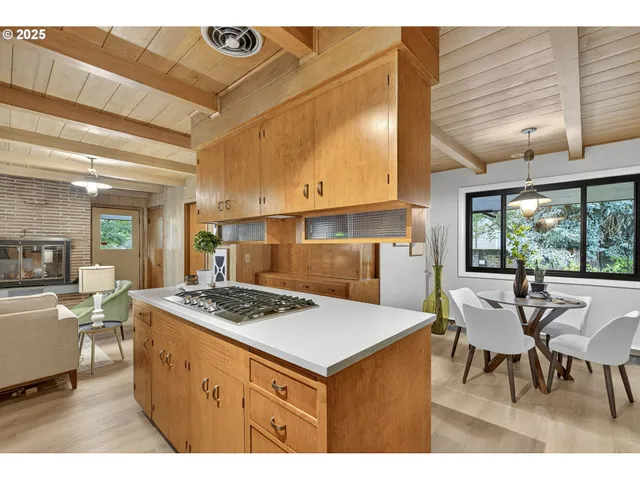 a kitchen with a stove a refrigerator and wooden cabinets