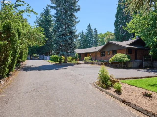 a front view of a house with a yard and outdoor seating